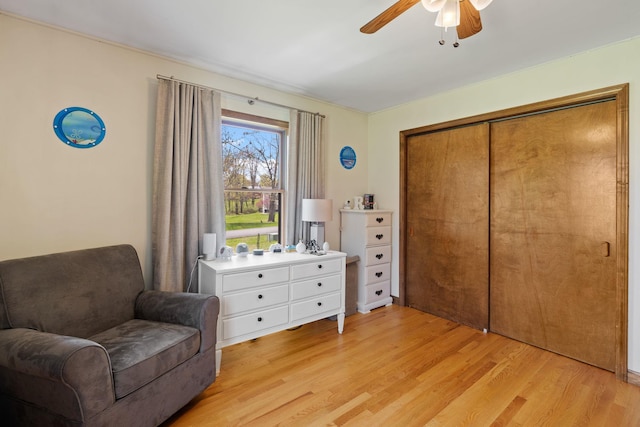 sitting room featuring ceiling fan and light wood-type flooring
