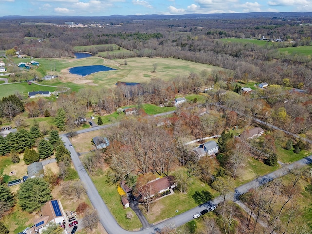 aerial view with a water view, view of golf course, and a wooded view