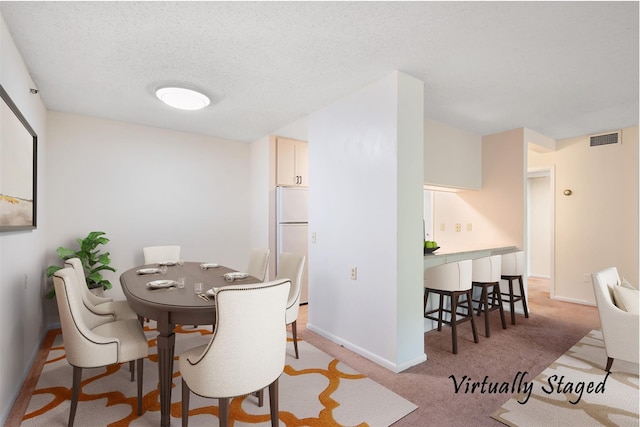 25 Rockledge Ave Unit 601, White Plains, NY 10601 - dining room with baseboards, light colored carpet, and a textured ceiling