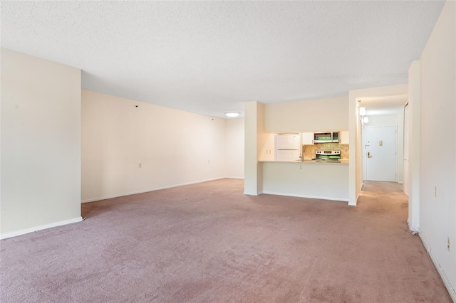 25 Rockledge Ave Unit 601, White Plains, NY 10601 - unfurnished living room with light colored carpet, baseboards, and a textured ceiling