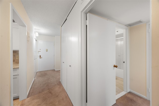 25 Rockledge Ave Unit 601, White Plains, NY 10601 - corridor featuring light carpet, a textured ceiling, and baseboards