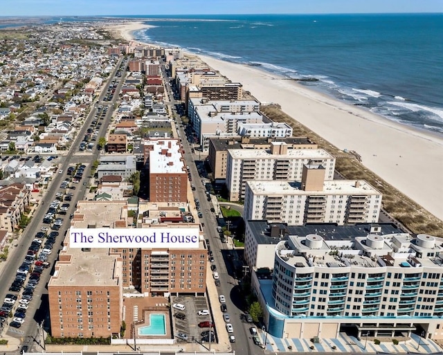 birds eye view of property featuring a water view and a view of the beach