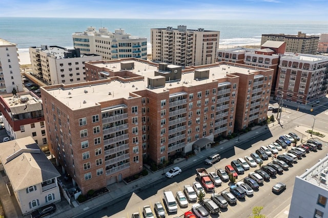 drone / aerial view with a city view and a water view
