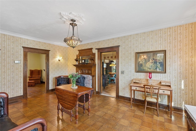 dining space with crown molding, baseboards, and wallpapered walls