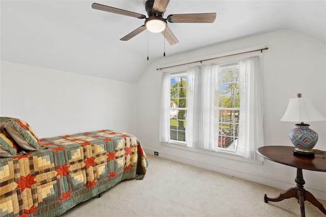 carpeted bedroom featuring ceiling fan, baseboards, and lofted ceiling