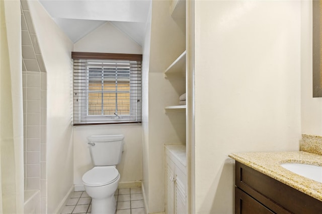 bathroom with tile patterned flooring, vanity, toilet, baseboards, and vaulted ceiling