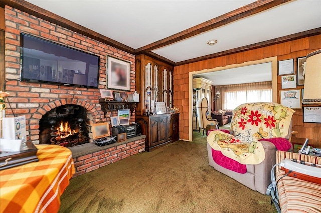 carpeted living room with wood walls, ornamental molding, beam ceiling, and a fireplace