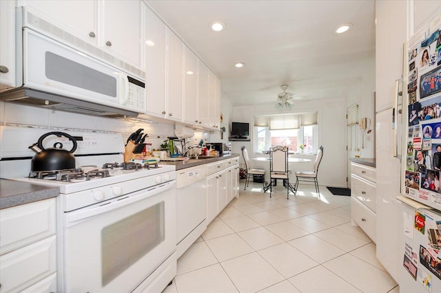 kitchen with a ceiling fan, light tile patterned floors, white cabinets, recessed lighting, and white appliances