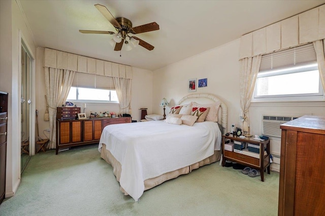 bedroom with ceiling fan and light colored carpet