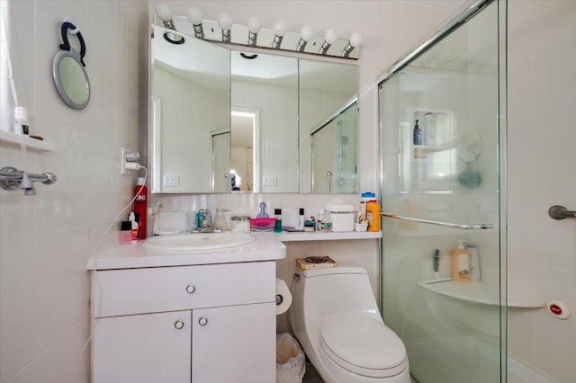 full bath with vanity, toilet, tile walls, backsplash, and a stall shower