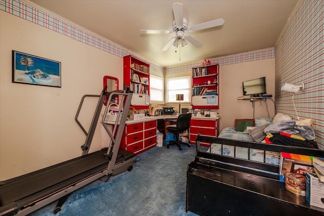 office space with ceiling fan, wallpapered walls, and dark carpet