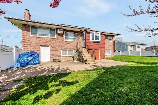 back of property with brick siding, a patio, a chimney, and an AC wall unit