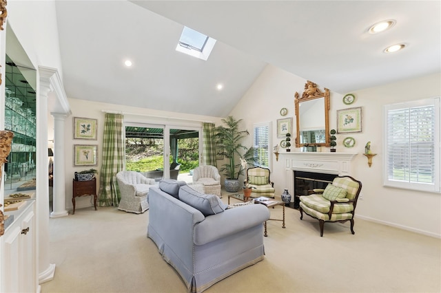 living area with recessed lighting, a skylight, light colored carpet, and a glass covered fireplace