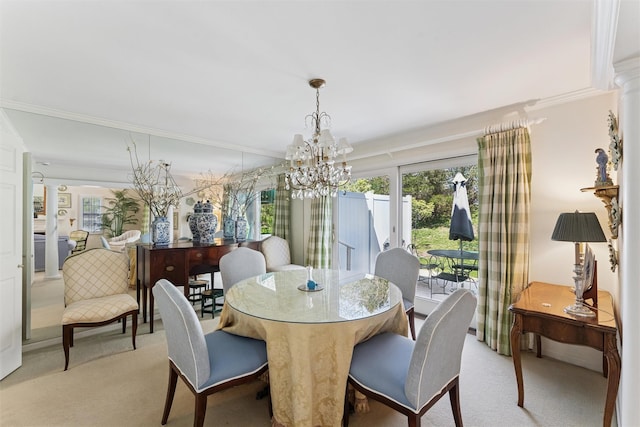 dining area featuring crown molding, light colored carpet, and a chandelier