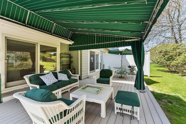 wooden terrace featuring a lawn, outdoor dining area, and an outdoor living space