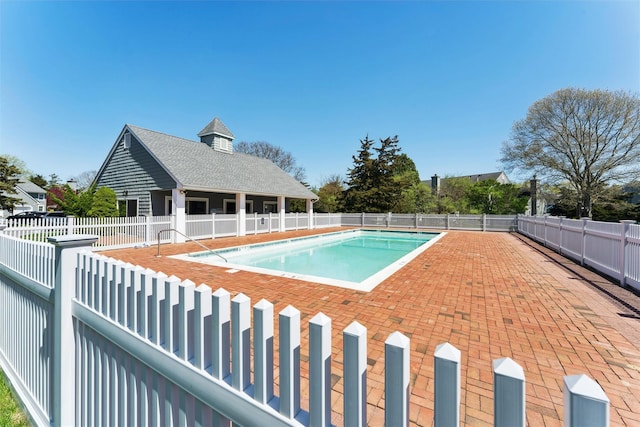 pool featuring fence and a patio