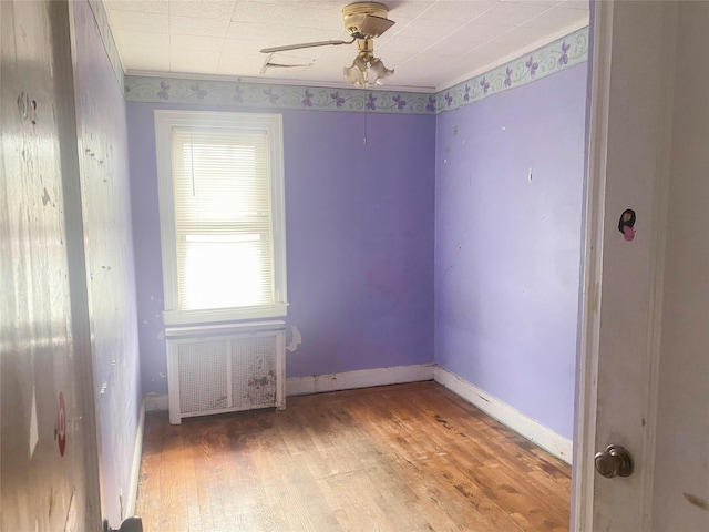 116-16 217th St, Cambria Heights, NY 11411 - empty room featuring ornamental molding, baseboards, radiator heating unit, light wood-type flooring, and a ceiling fan