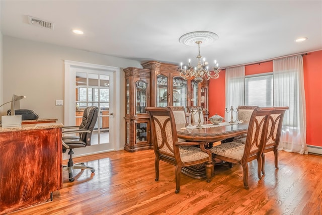 dining room with visible vents, light wood-style floors, a chandelier, and a wealth of natural light