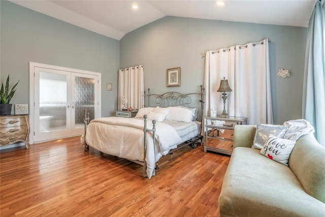 bedroom with recessed lighting, high vaulted ceiling, french doors, and light wood-type flooring