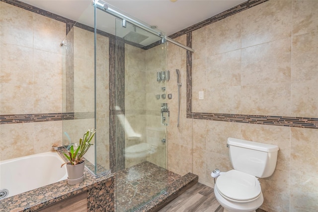 full bath featuring toilet, tile walls, a shower stall, and wood finished floors