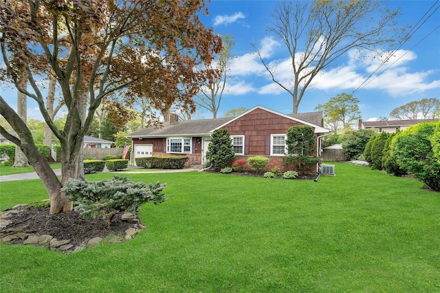 ranch-style house featuring brick siding, fence, a chimney, and a front lawn