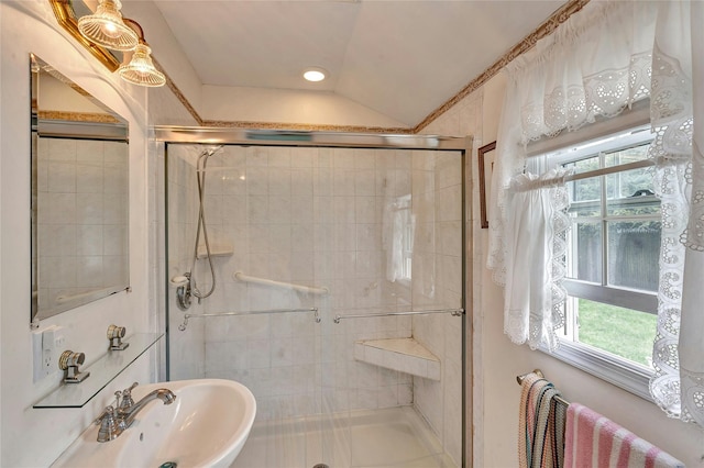 full bathroom with a sink, lofted ceiling, and a stall shower
