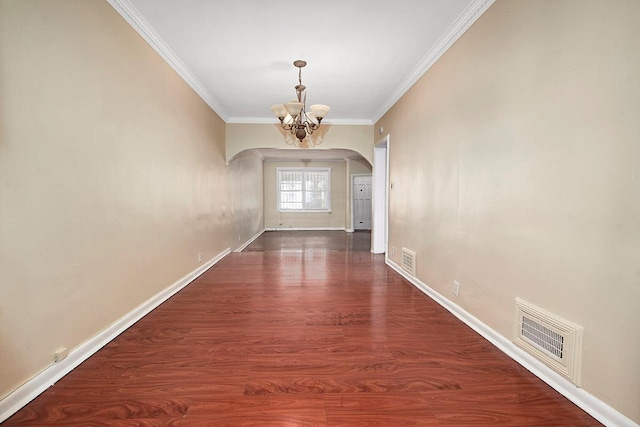 doorway to outside with visible vents, ornamental molding, baseboards, a chandelier, and arched walkways