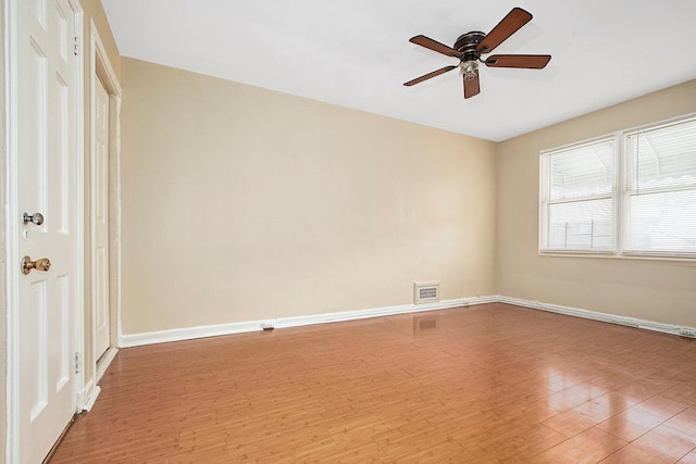 empty room with a ceiling fan, baseboards, visible vents, and light wood-style floors