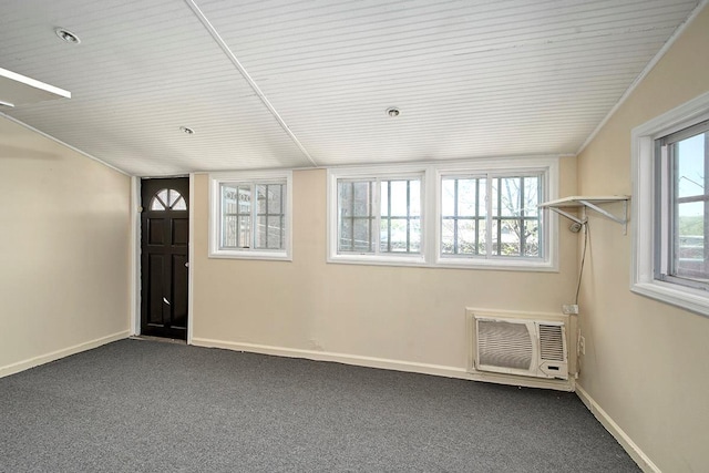 interior space with baseboards, wood ceiling, and a wall mounted AC