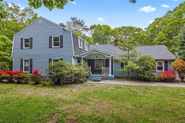7 E Gate Ln, Setauket, NY 11733 - dutch colonial featuring a chimney, a porch, a front lawn, and a shingled roof