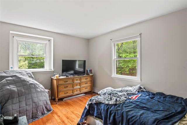 7 E Gate Ln, Setauket, NY 11733 - bedroom with multiple windows, light wood-type flooring, and a baseboard radiator