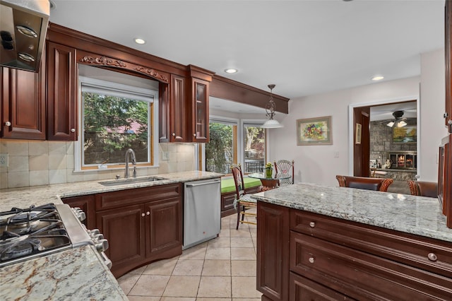 kitchen featuring hanging light fixtures, a sink, stainless steel appliances, recessed lighting, and decorative backsplash