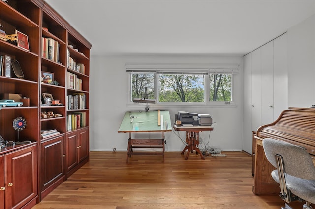 home office with baseboards and light wood-style floors