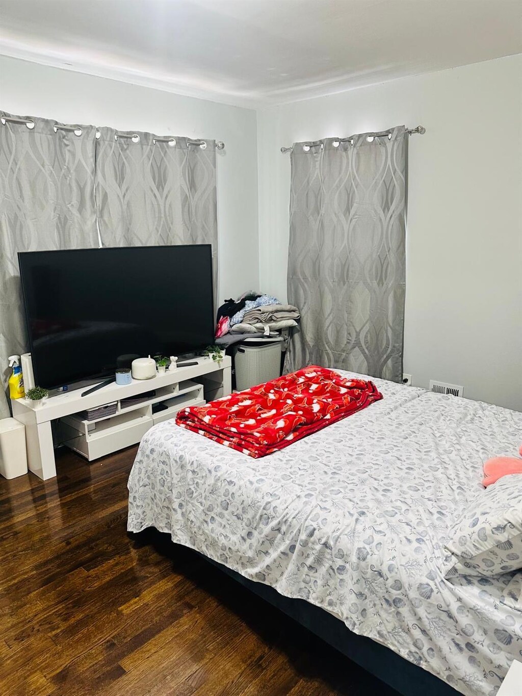 bedroom with visible vents and wood finished floors