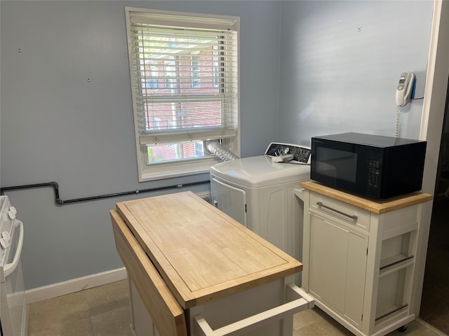 washroom featuring baseboards and washer / dryer