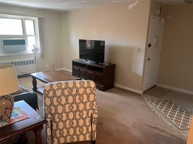 living area with baseboards, light carpet, and radiator