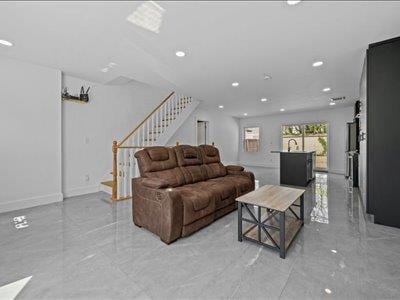 66-39 Jay Ave, Maspeth, NY 11378 - living area with recessed lighting, marble finish floor, baseboards, and stairway