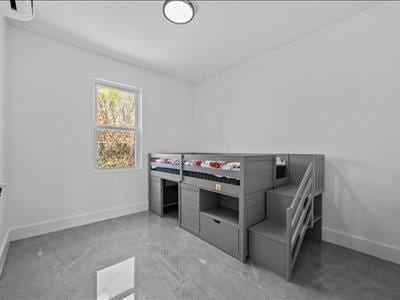 66-39 Jay Ave, Maspeth, NY 11378 - unfurnished bedroom featuring baseboards