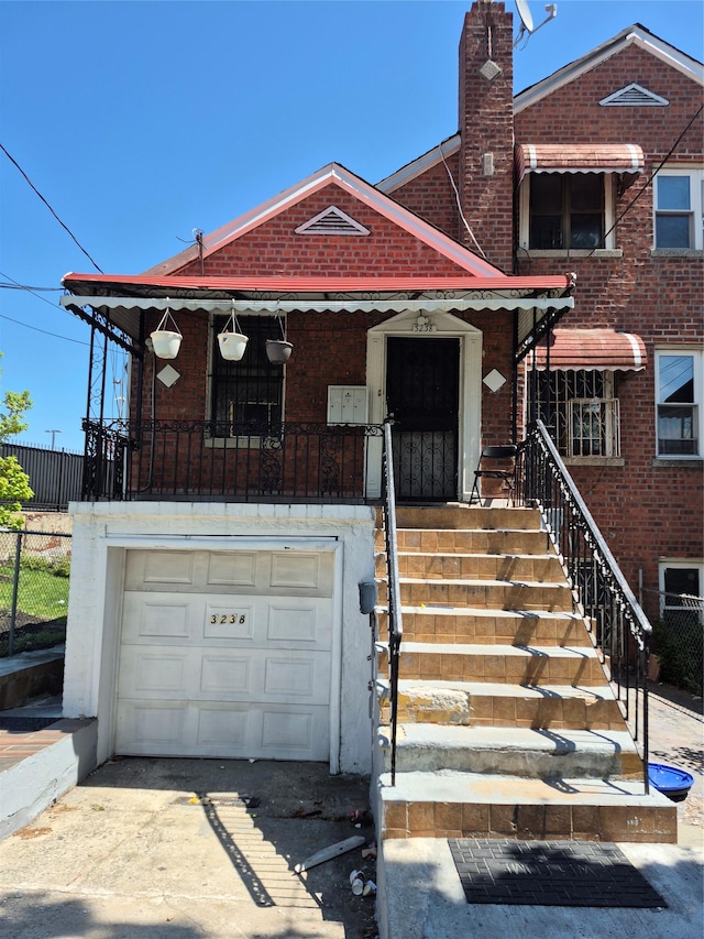 3238 Tenbroeck Ave, Bronx, NY 10469 - townhome / multi-family property featuring fence, an attached garage, a chimney, and brick siding