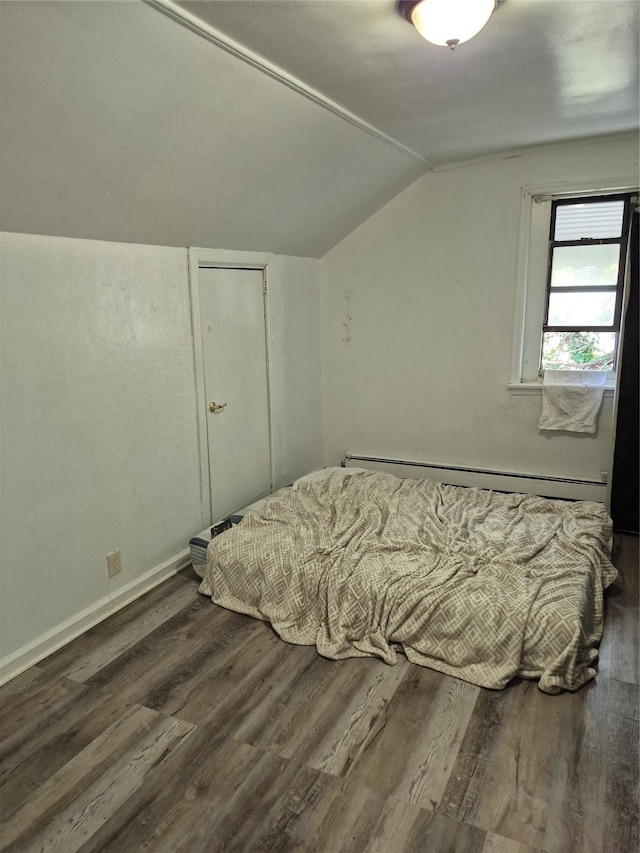 3238 Tenbroeck Ave, Bronx, NY 10469 - bedroom with wood finished floors, baseboards, lofted ceiling, and baseboard heating