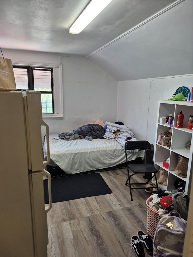 3238 Tenbroeck Ave, Bronx, NY 10469 - bedroom featuring freestanding refrigerator, wood finished floors, and lofted ceiling