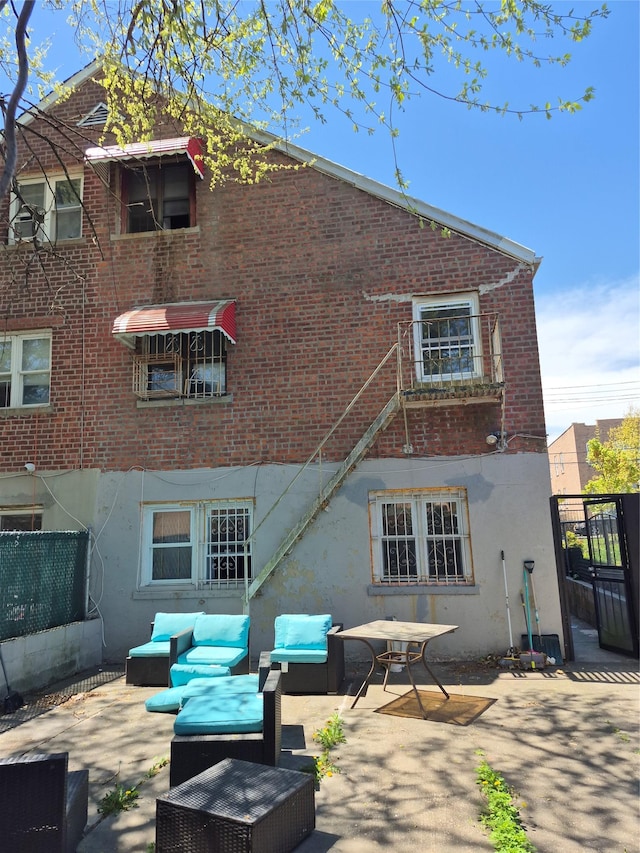 3238 Tenbroeck Ave, Bronx, NY 10469 - rear view of property featuring brick siding, stucco siding, and a patio