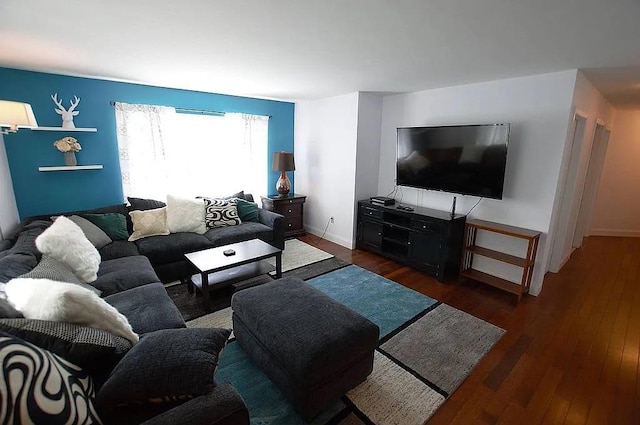 living area with baseboards and dark wood-style flooring