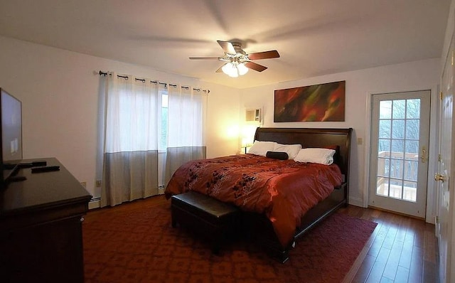 bedroom with access to exterior, a wall mounted air conditioner, a baseboard heating unit, hardwood / wood-style flooring, and a ceiling fan