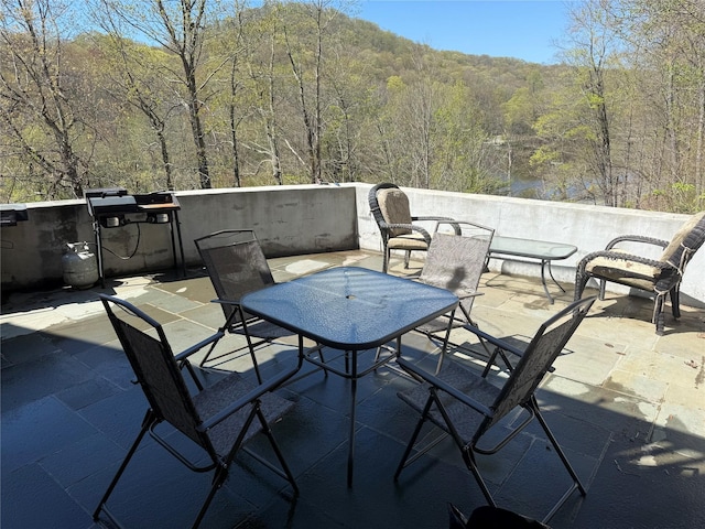 view of patio / terrace with a wooded view