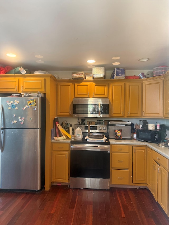 kitchen with light countertops, stainless steel appliances, and dark wood-style floors