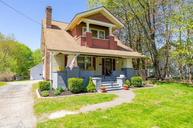 7365 S Broadway, Red Hook, NY 12571 - bungalow-style home with roof with shingles, a garage, a porch, a front yard, and a chimney
