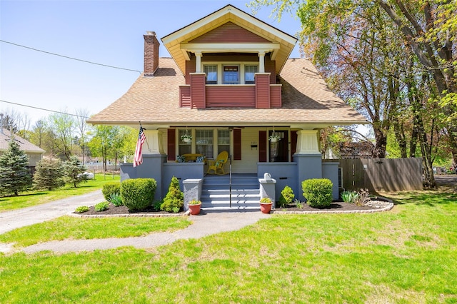 7365 S Broadway, Red Hook, NY 12571 - bungalow-style house featuring a front lawn, fence, a chimney, a shingled roof, and a porch