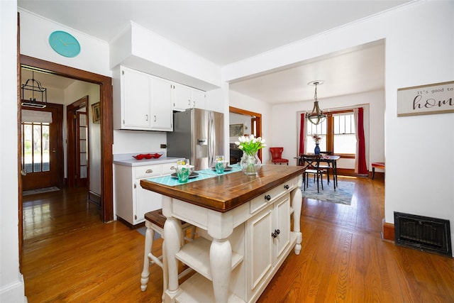 7365 S Broadway, Red Hook, NY 12571 - kitchen featuring visible vents, dark wood finished floors, stainless steel fridge with ice dispenser, white cabinets, and wood counters