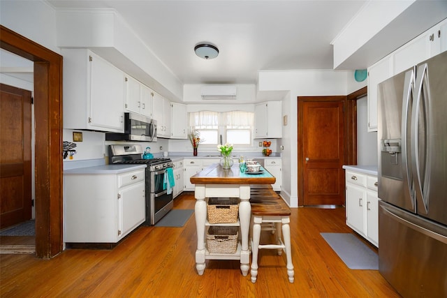7365 S Broadway, Red Hook, NY 12571 - kitchen featuring light countertops, a wall unit AC, white cabinets, and stainless steel appliances